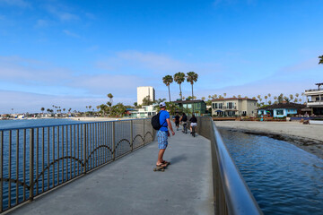 People walking and Skateboarding on a Bridge in Mission Bay, California