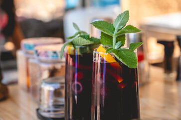 Summer cocktail delight: close-up of a vibrant cold wine cocktail with fruits and mint