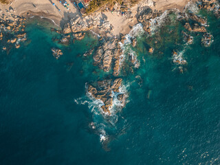 Top down of Conchas Chinas Beach in Puerto Vallarta Mexico showing rock formations in ocean.