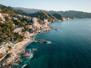 High aerial view of Conchas Chinas Beach and it nearby hotels in Puerto Vallarta Mexico. - obrazy, fototapety, plakaty