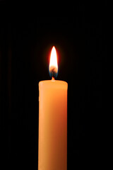 Closeup of a burning candle in the dark...