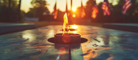 An eternal flame at a military memorial with an American flag in the background, illuminated by morning light that casts soft shadows around the sacred symbol. , natural light, sof