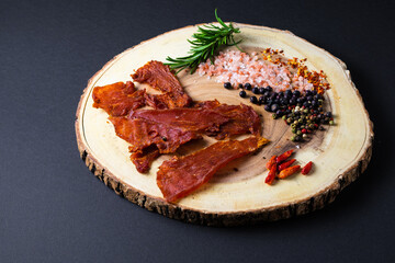 Beef jerky pieces isolated on a white and black background