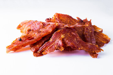 Beef jerky pieces isolated on a white and black background