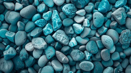 A detailed texture of blue pebbles, creating a soothing and abstract natural background - obrazy, fototapety, plakaty