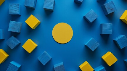 A simple and vibrant composition featuring blue toy cubes and a yellow circle arranged on a dark blue backdrop