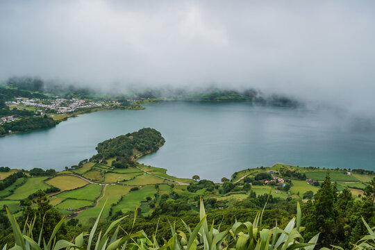 Cerrado das Freiras viewpoint with Sete Cidades lagoon, green fields and fog, São Miguel - Azores PORTUGAL