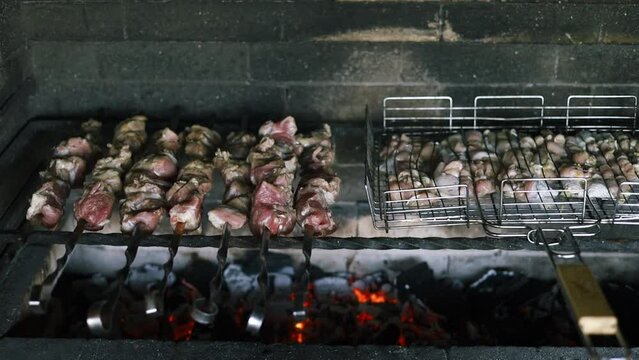 Barbecue party. Cooking delicious meat at outdoor charcoal grill