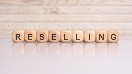wooden blocks spelling 'RESELLING' on a gray background