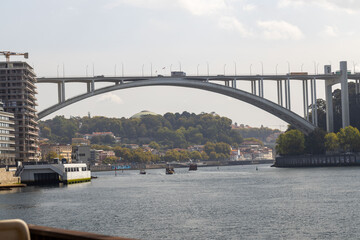 Ponte da Arrabida bridge from the west - boats on the river - low angle shot with a standard lens