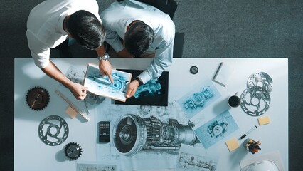 Top down aerial view of manager sitting while answer question about jet engine. Professional...