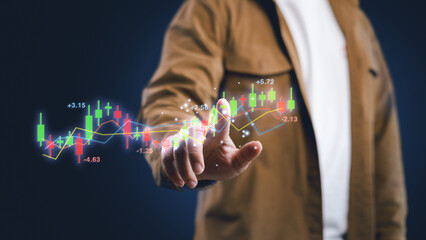 A man is pointing at a candlestick chart and trending line graph on virtual screen. Concept of...