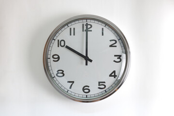 A round shape stainless steel wall clock with white face and hands set to 10 o'clock time. The...