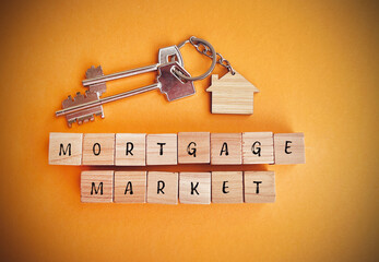 Wooden cubes with the word mortgage market and keys