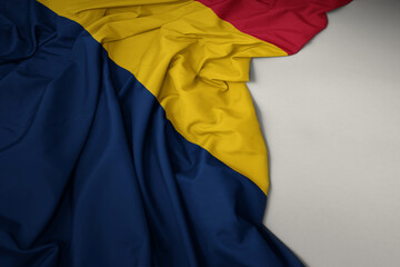 waving national flag of chad on a gray background.