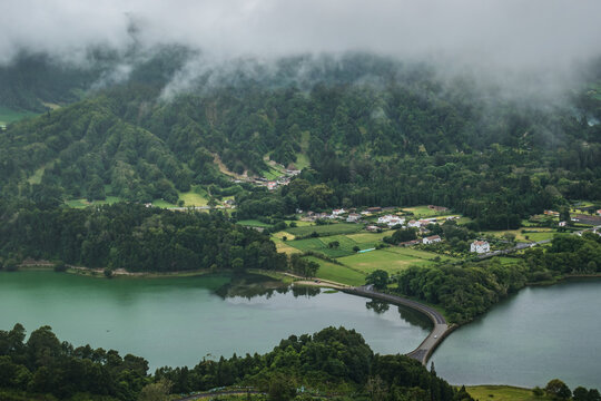 Aerial view to Sete Cidades Lagoon fields and typical vegetation with fog on the mountain, São Miguel - Azores PORTUGAL