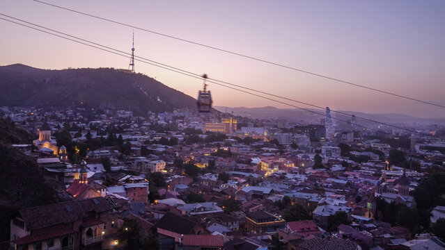 Drone point of view in evening illuminated Tbilisi