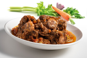 Isolated Bowl with a portion of oxtail stewed vaccinara and vegetables