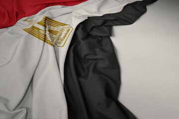 waving national flag of egypt on a gray background.