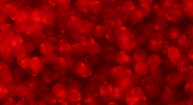 Abstract shiny bright red glitter HD video background. Red glitter background with sparkling texture. Ruby shimmering light, sequins sparks and glittering glow foil background