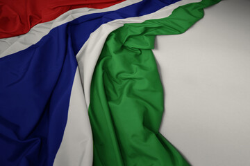 waving national flag of gambia on a gray background.