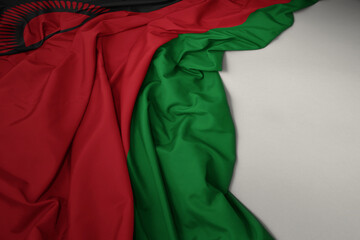 waving national flag of malawi on a gray background.