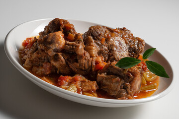 Isolated Bowl with a portion of oxtail stewed vaccinara