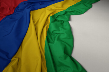waving national flag of mauritius on a gray background.