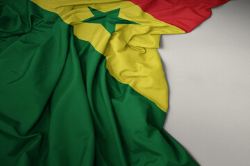 waving national flag of senegal on a gray background.