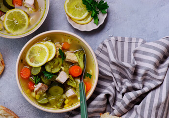 Vegetable soup with baked chicken and lemon .top veiw .style hugge