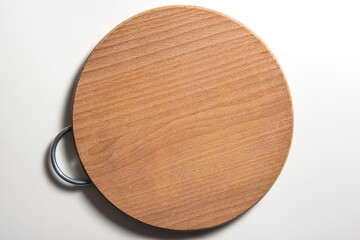 Isolated empty round wooden chopping board