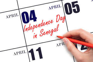 April 4. Hand writing text Independence Day in Senegal on calendar date. Save the date.