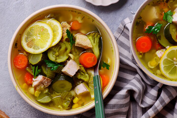 Vegetable soup with baked chicken and lemon .top veiw .style hugge