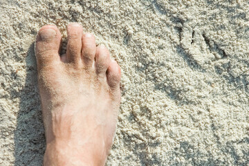 beautiful legs in the sand of the sea greece background