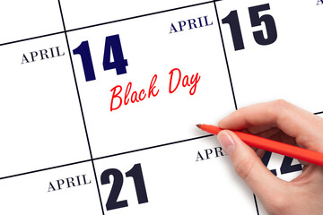 April 14. Hand writing text Black Day on calendar date. Save the date.