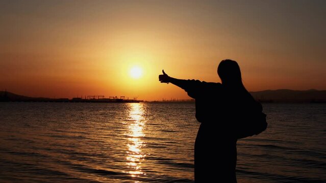 Woman Silhouette Okay With her Hand in Sunset Light