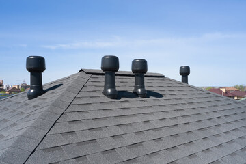 Ventilation pipes in asphalt shingle roofs