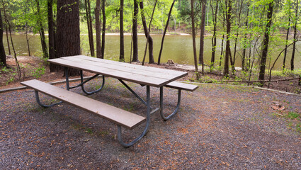 Empty picnic bench near a body of water - Powered by Adobe