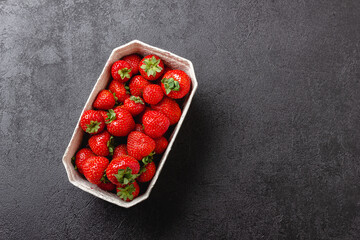 Strawberries in paper basket with copy space