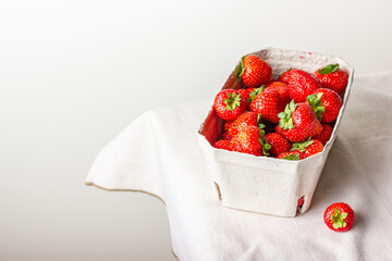 Strawberries in paper basket © Belashova