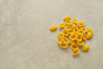 Fototapeta na wymiar Uncooked pasta on gray background