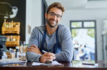 Happy businessman or coffee shop owner with documents or agenda for planning menu and recipes in...