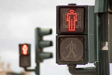 Red pedestrian crossing traffic light with blurred background of another traffic light