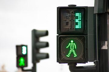 Green traffic light for pedestrians counting down in 3 seconds in Lisbon