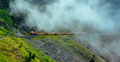 Mountains train in Alps in a foggy weather