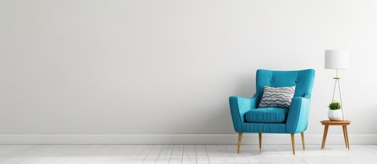 Simple room with a blue armchair, side table, and white lamp.