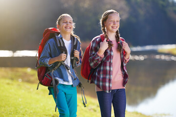 Girls, nature and backpack for walk, river and exercise for outdoor travel holiday. Fitness, smile...