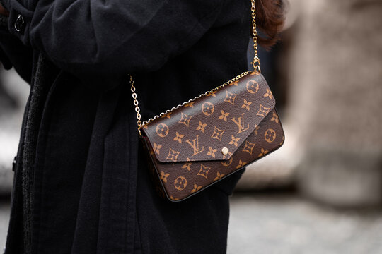 Milan, Italy - January, 10, 2024: woman wears Louis Vuitton bag, fashion blogger outfit details