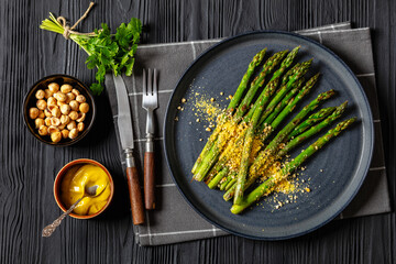 roasted asparagus with nut yeast crumble on plate
