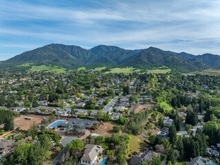 Fototapeta na wymiar Drone landscape photos over the beautiful landscape of Clayton, California with homes, streets and green hills.